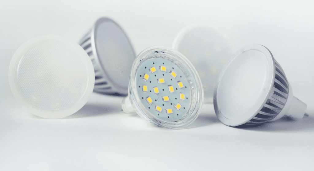 Five round led bulbs with a flat fascia. The central diode has its opaque fascia removed showing the individual light diodes arranged concentrically within the bulb.